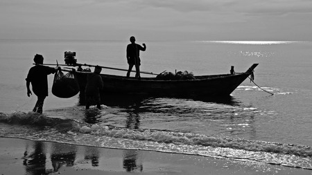 silhouette scene of fishermen on the fishing boat in Hua Hin, Black and white conceptの写真素材