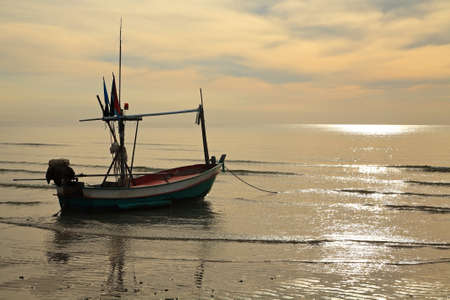 fishing boat on sea at sunrise in Hua Hin, Thailandの写真素材