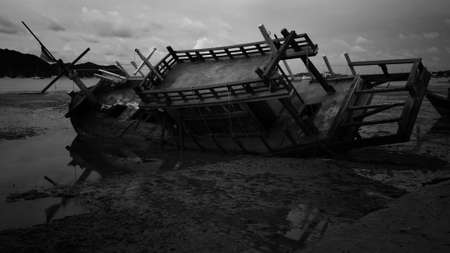 shipwreck - destroyed fishing boat near the shore in Phuket, Thailandの写真素材