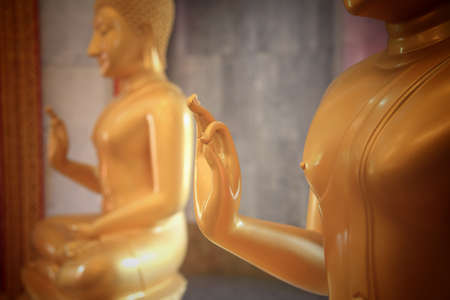 Golden Buddha gesture hand at Thai temple, closeup focus on handの写真素材