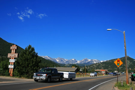 COLORADO, US - JULY 01, 2008: Vehicles on countryside street with the view of Rocky mountain national park.のeditorial素材