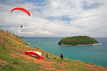 PHUKET,THAILAND - MAY 23, 2015: unidentified man preparing to fly the paramotor to enjoy Andaman sea at windmill viewpoint in Phuket.のeditorial素材