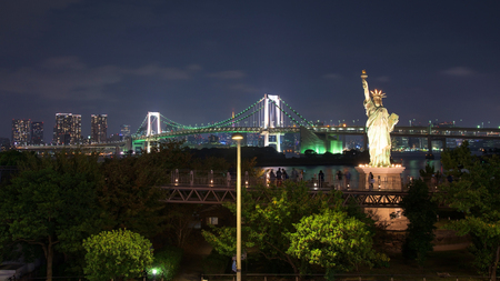 Japan skyline of Liberty statue and rainbow bridge from Odaibaの写真素材