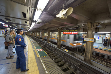 TOKYO, JAPAN - NOVEMBER 07, 2015: Unidentified people wait subway train in Tokyo Metro pass. The transit system carries almost 8 million passengers a day.のeditorial素材