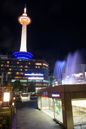 KYOTO, JAPAN - NOVEMBER 10, 2015: Kyoto Tower with colorful fountain show. Here, found in 1964, is the tallest structure in Kyoto located opposite of Kyoto Station.のeditorial素材