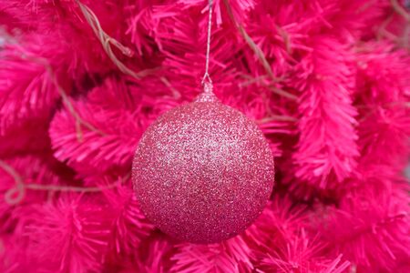 Pink ball decorated on pink Christmas treeの写真素材