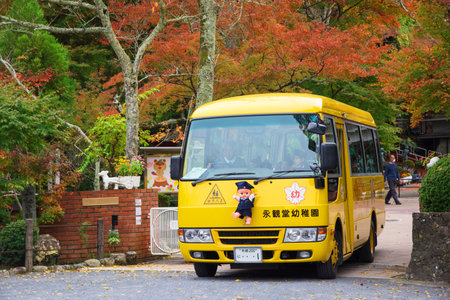 KYOTO, JAPAN - NOVEMBER 13, 2015: Unidentified children in cute school bus on the way the send students back from school.のeditorial素材