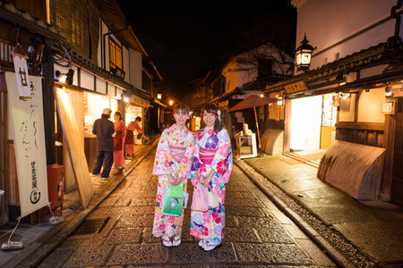 KYOTO, JAPAN - NOVEMBER 13, 2015: Unidentified beautiful Japanese girls with Traditional Kimono dress at old town in Higashiyama District at night.のeditorial素材