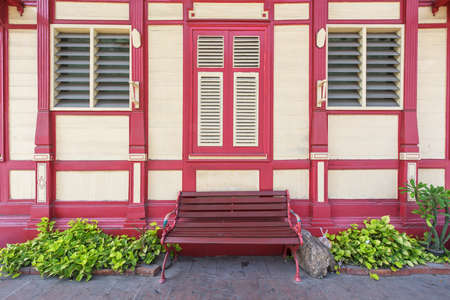 Red chair in front of vintage wooden building in Hua Hin, Thailandの写真素材