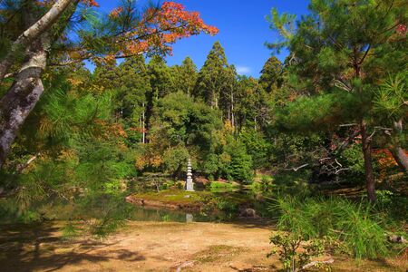 Small pagoda with autumn foliage garden at Kinkakuji temple in Kyoto, Japanの写真素材