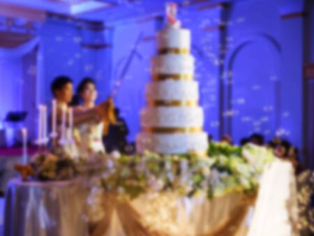 Blur abstract of bride and groom cut cake on wedding ceremonyの写真素材