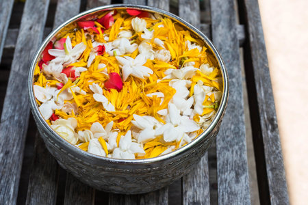 Songkarn holy water in Silver bowl on wooden tableの写真素材