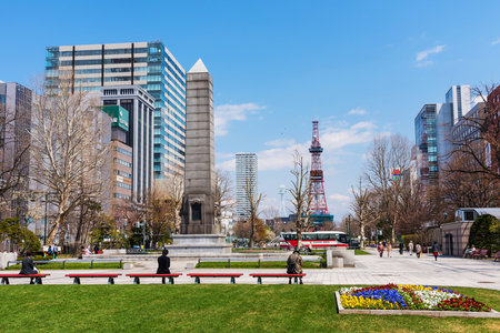 SAPPORO, JAPAN - APRIL 25, 2016: Unidentified people relax at Odori park,  the central park with TV Tower view at Sapporo.のeditorial素材
