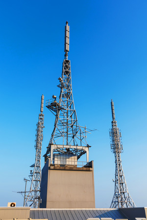 antenna repeater, sattelite, 3g, 4g tower on blue skyの写真素材