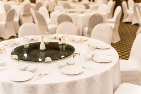 White wedding table setting for guests to have dinnerの写真素材
