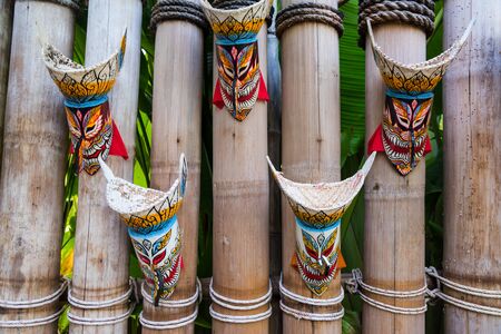 Thai ghost mask, Phi Ta Khon, decorated on the wooden bamboo wallの写真素材