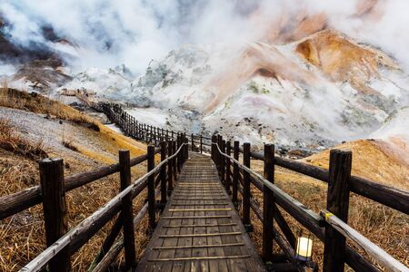 Jigokudani hell valley walking trail, Noboribetsu, Hokkaido, Japan. Selective focus at front banister of wooden footpath.の写真素材