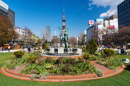 SAPPORO, HOKKAIDO, JAPAN - APRIL 24, 2016: dance woman statues stand in front of sapporo TV tower in Odori Park.のeditorial素材