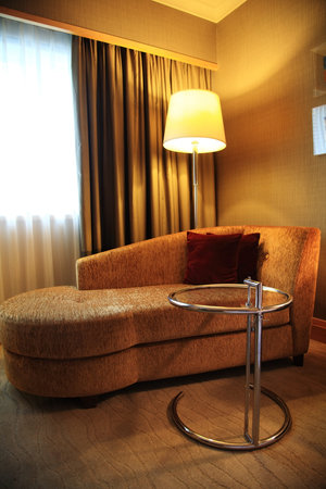 Modern sofa in stylish hotel room with table and lampのeditorial素材