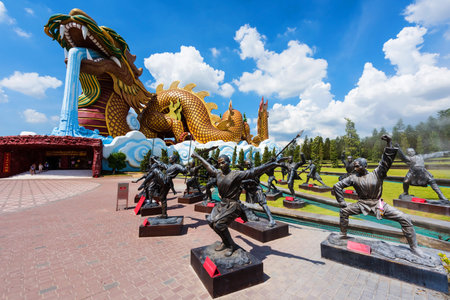 SUPHANBURI, THAILAND - JULY 18, 2016: Giant Dragon monument and Chinese Kung fu statues at City Pillar Shrine of Suphanburi Province.のeditorial素材