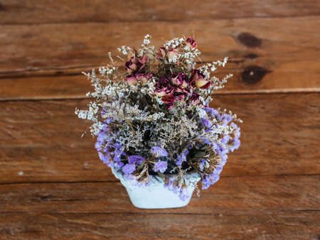 flowers in pot on wooden table by top viewの写真素材