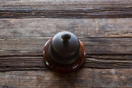 Classic service bell on wooden table by top view