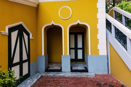 Green door and yellow wall of classic houseの写真素材