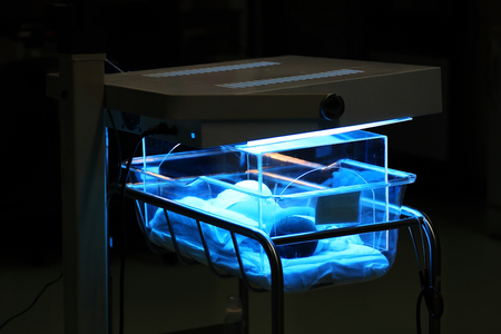 newborn boy treated by ultraviolet light in incubator to solve jaundice issueの写真素材