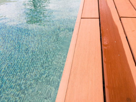 Modern swimming pool with the wooden path