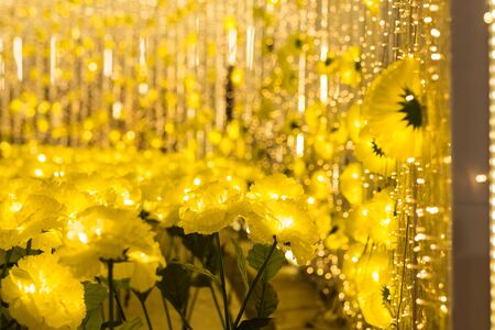 Fake yellow flowers with bokeh abstract decorated for Christmas or x'mas eventの写真素材