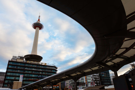 KYOTO, JAPAN - NOVEMBER 23, 2016: Kyoto tower against blue sky with curve bus platform at Kyoto station.のeditorial素材