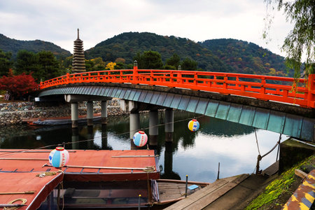 Red bridge above Uji River and thirteen storied pagoda, Kyoto, Japanのeditorial素材
