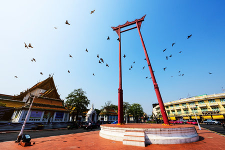 BANGKOK, THAILAND, FEBRUARY 13, 2017:  Red giant swing or Sao Chingcha built in 1784 with many flying pigeon birds near city hall.のeditorial素材