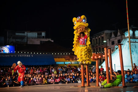 KORAT, THAILAND - JANUARY 28, 2017: group of people perform lion dance on column during Chinese new year's celebration in Nakhon Ratchasima downtown.のeditorial素材