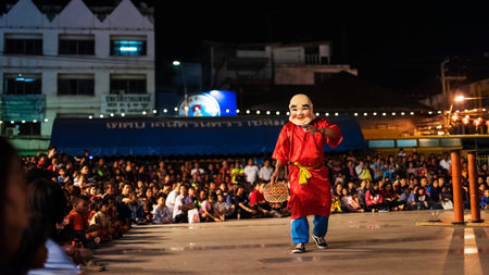 KORAT, THAILAND - JANUARY 28, 2017: Unidentified man with  smile face mask to perform Lion danceのeditorial素材