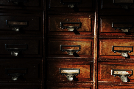 Antique wooden cupboard or cabinet with dirty label  touching sunlightの写真素材