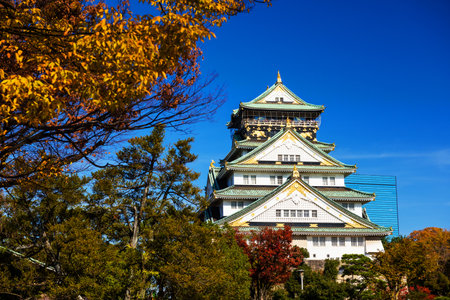 Osaka Castle with autumn leaves against blue sky. Japanのeditorial素材