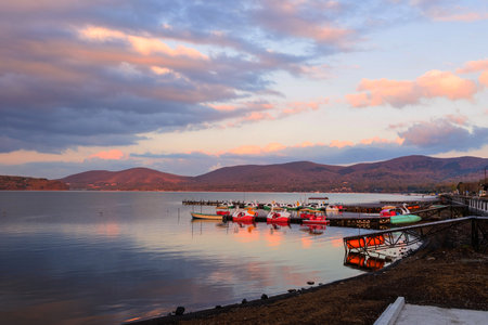 Lake Yamanaka with floating recreation boats with twilight sky at dusk, Yamanashi, Japanのeditorial素材