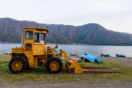 Excavator Loader with backhoe or earth moving works near the lakeの写真素材