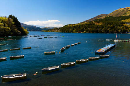 Fishing boats and Red Torii gate on lake Ashi, Hakone, Japanの写真素材
