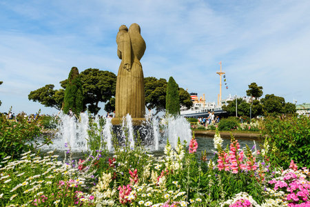 YOKOHAMA, JAPAN - MAY 6, 2017: Unidentified people at fountain and angel statue in Yamashita Park against blue sky.のeditorial素材