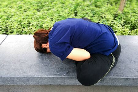 Yoga woman perform back stretching exercise at green park garden backgroundの写真素材