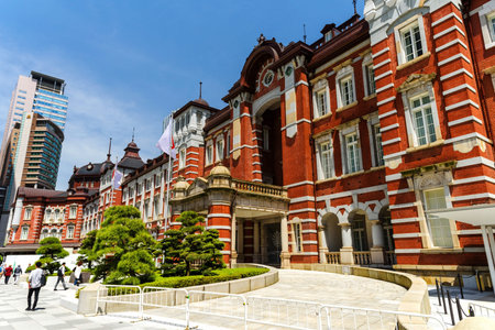 TOKYO, JAPAN - MAY 8, 2017: Unidentified people at Tokyo Station antique building against blue sky...