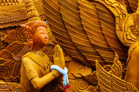 Thai carving wax angel for candle festival. The big candle used in the temple during the raining seasonのeditorial素材