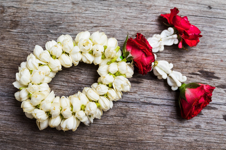 Thai flower garland on old wooden table backgroundの写真素材