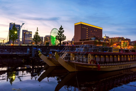 YOKOHAMA, JAPAN - MAY 6, 2017:  Ships at the dock of Minato Mirai waterfront district at dusk with twilight sky.のeditorial素材