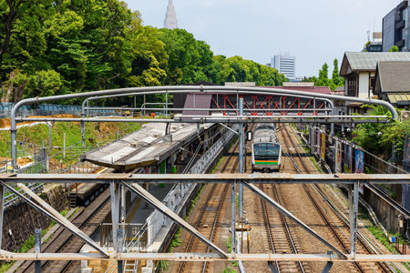 TOKYO, JAPAN - MAY 7, 2017: Local JR train of Yamanote Line reaching to Harajuku station. Here is famous of Tokyo teenager fashion and Meiji shrineのeditorial素材