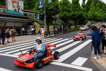 TOKYO, JAPAN - MAY 7, 2017: Unidentified man with Doraemon suit driving small racing car to promote VDO game at Harajuku station.のeditorial素材