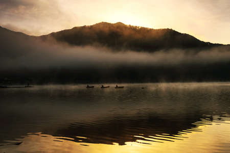 Silhouette lake Shoji scenic of fishing at sunriseの写真素材