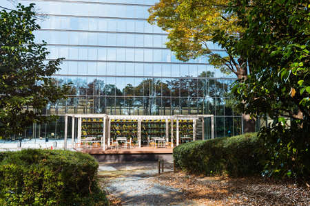 Beautiful garden and rest tables and seats near modern grass buildingの写真素材